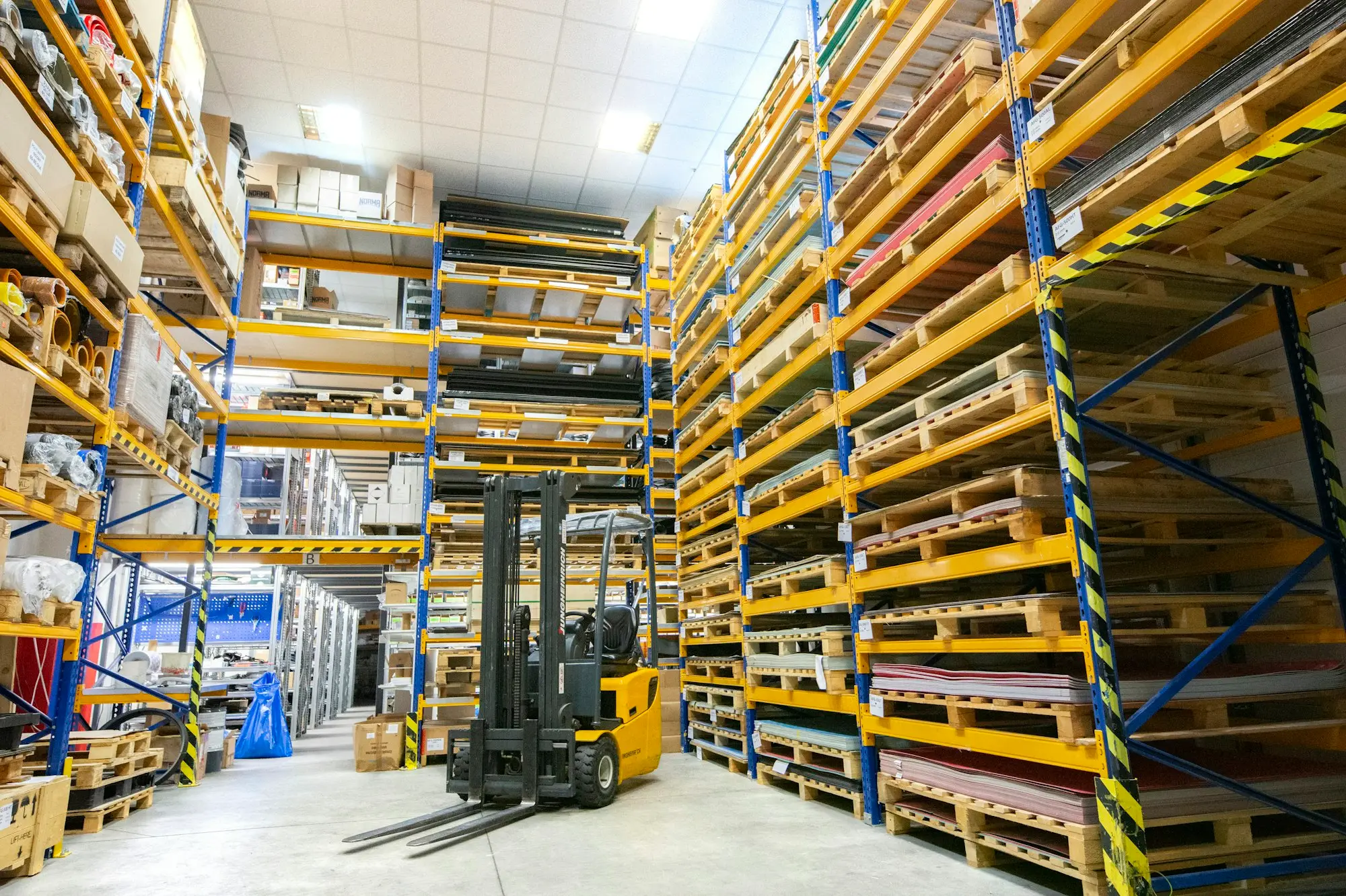 Fulfilment warehouse with tall pallet racking and a forklift