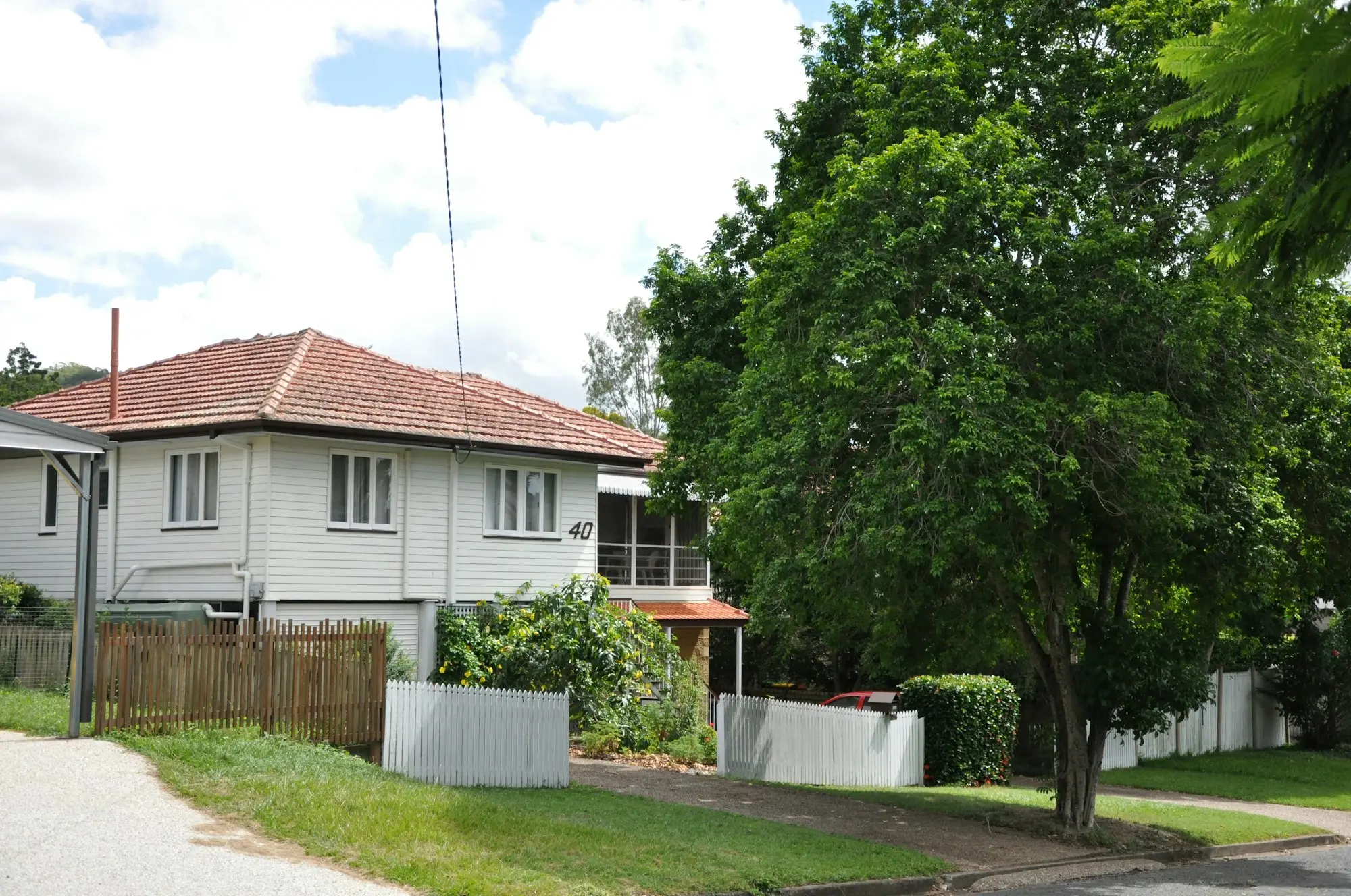 Raised Queenslander house on a leafy street in Indooroopilly, Brisbane